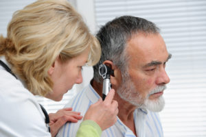 an otoscope being used on a patient